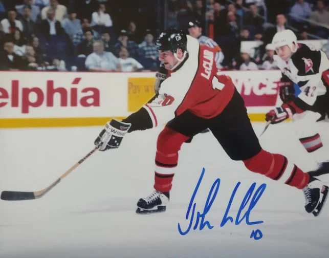 John LeClair in Action Philadelphia Flyers Autographed 8" x 10" Hockey Photo